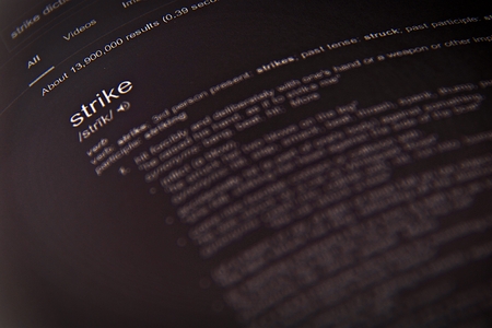 Business concept : Dictionary definition of the word strike, close up, selective focusの写真素材