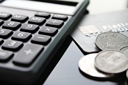 Business, finance, credit card, shopping, saving money, banking, loan, investment, taxes or accounting concept : Credit card, calculator and coins on office desk tableの写真素材