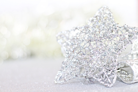 Happy New Year, Merry Christmas, celebration or holiday background concept : Shiny silver star ornaments on bright abstract background bokehの写真素材