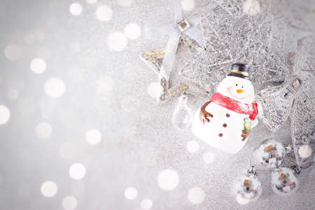 Happy New Year, Merry Christmas, celebration or holiday background concept : Cute santa claus doll and shiny silver ornaments on bright background, Top view or flat lay with copy spaceの写真素材