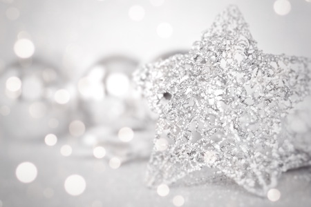 Happy New Year, Merry Christmas, celebration or holiday background concept : Star and shiny silver ornaments on bright abstract background bokehの写真素材