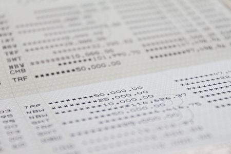 Business, finance, savings or accounting concept : Savings account passbook or financial statement on tableの写真素材