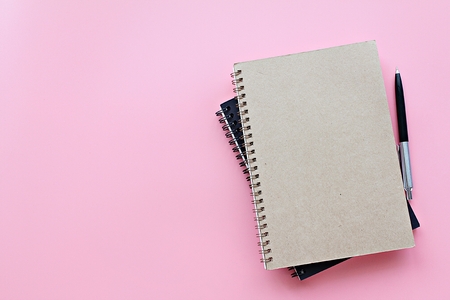 Still life, business, office supplies or education concept : Top view or flat lay of notebooks and pen on pink background, ready for adding or mock upの写真素材