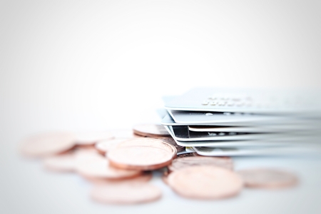 Business, finance, shopping, loans or money management concept : Credit cards and coins close up shot with soft focus for backgroundの写真素材