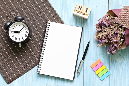 Business, still life, working, holiday or new year planning concept : Desk table with open notebook...