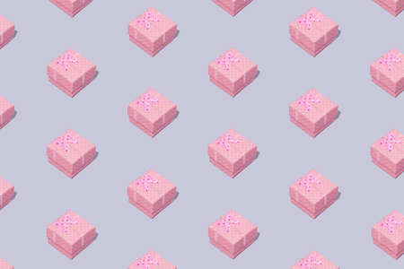 Pattern with pastel pink gift boxes on grey background. Minimal composition.