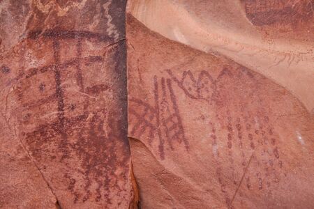 Petroglyphs on pink sandstoneの写真素材