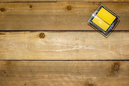 Sticky note dispenser on distressed wooden backgroundの写真素材
