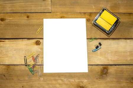 Sticky note dispenser with paperclips and blank vertical 8.5x11 for your copy on distressed wooden backgroundの写真素材