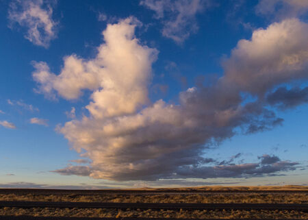 Dramatic late afternoon clouds in New Mexico sky along highwayの写真素材