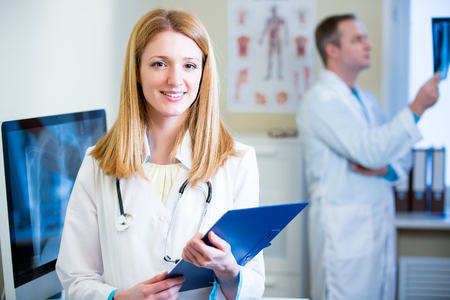 Portrait of friendly confident doctors in hospital. Enthusiastic medical staff at work. Female doctor with stethoscope looking at the camera.の写真素材