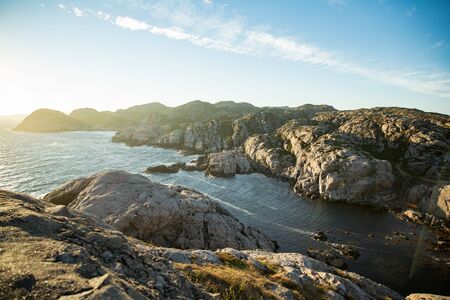 Serene Scandinavian summer landscape on south coast of Norway. Rocky Mountains, fjord from top. Sunset sky. Lindesnesの写真素材