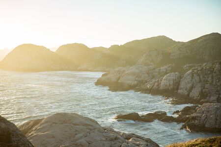 Serene Scandinavian summer landscape on south coast of Norway. Rocky Mountains, fjord from top. Sunset sky. Lindesnesの写真素材
