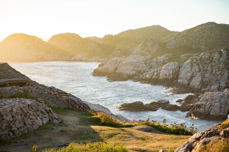 Serene Scandinavian summer landscape on south coast of Norway. Rocky Mountains, fjord from top. Sunset sky. Lindesnesの写真素材