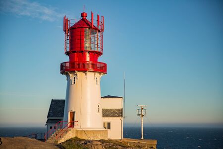 Old Lighthouse Lindesnes fyr is a coastal lighthouse located on the southernmost point of continental Norway in Lindesnes, South Cape. Serene Scandinavian landscape, Rocky Mountains, fjord, sunset skyの写真素材