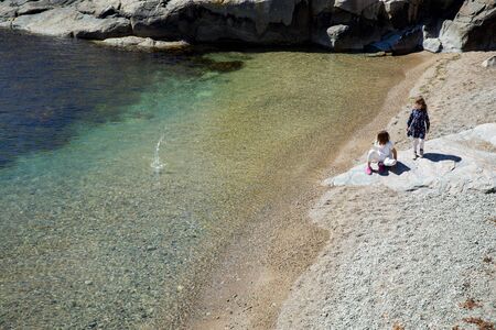 Serene scandinavian summer landscape on south coast of Norway. Sunny rocky beach with turquoise quiet water.の写真素材