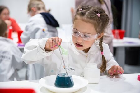 Helsinki, Finland - June 10, 2019: Finnish science center Heureka in Vantaa. Children's chemical laboratory in the scientific-interactive Museum. A little girl is passionate about chemical experimentsのeditorial素材