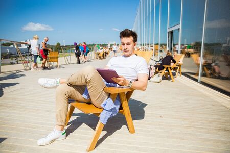 Helsinki, Finland- July 25 2019: New Helsinki central library Oodi exterior. Modern northern architecture. Outdoor upper floor lounge space. People relaxing, enjoying sunshine and city view.のeditorial素材