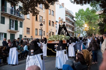 Palma, Spain - April 18 2019: Holy Thursday procession of church brotherhood penitents in conical...