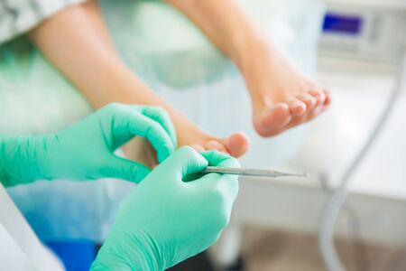 Woman sitting in chair, having foot treatment in spa salon.の写真素材