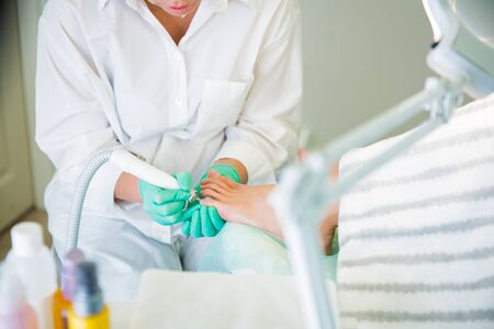 Woman sitting in chair, having foot treatment in spa salonの写真素材