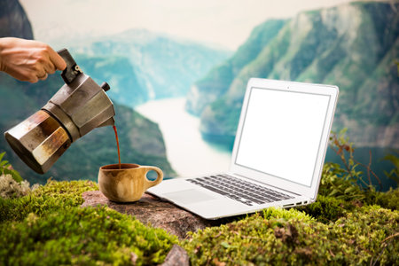 A freelancers digital nomads morning coffee with a Moka coffee maker, traditional wooden Finnish cup...