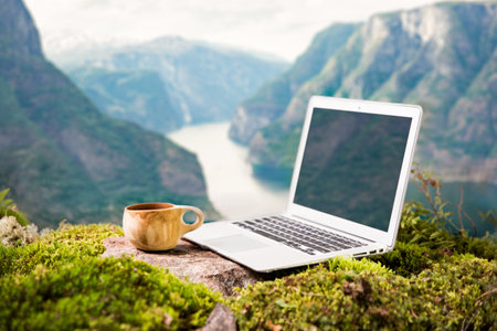 A freelancers digital nomads morning coffee with a Moka coffee maker, traditional wooden Finnish cup...