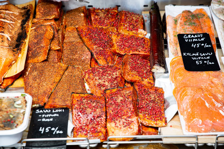 Appetizing fried fish at a food market in Finland. Various smoked fish products.の写真素材