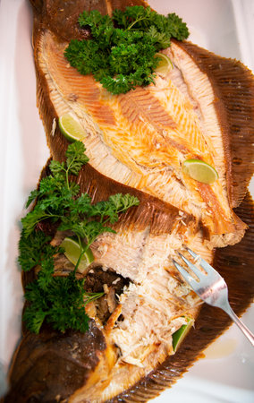 Dish with the smoked European flounder (Baltic flounder) on the buffet table in the restorant....
