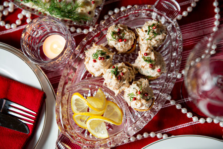 Festive fish table with smocked salmon salad on tartlet shells. Celebration delicacies on Christmas...
