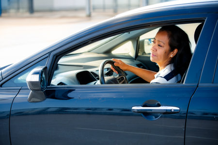 Middle aged woman of color driving car with focus on business, mobility, and diversity in todays...