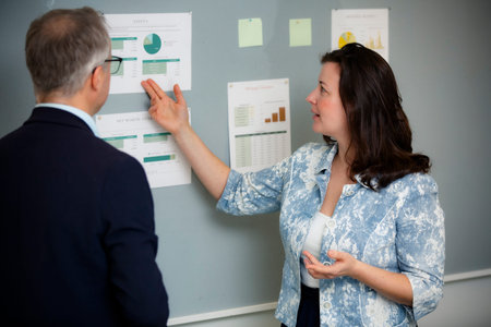 Confident female financial advisor explaining mortgage options and business investment strategy to...