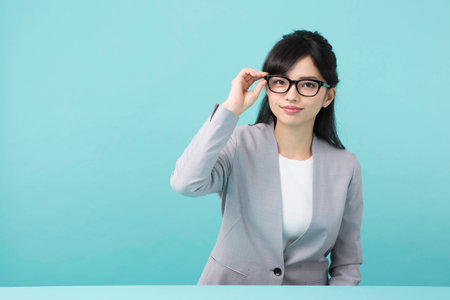 A woman with black rim glasses smilingの写真素材
