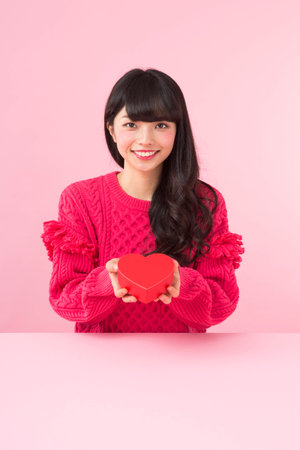 A woman holding a heartの写真素材