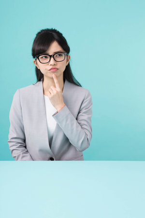 A woman with glasses put hand on the headの写真素材