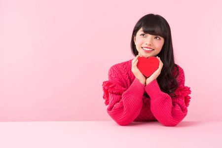 A woman holding a heartの写真素材