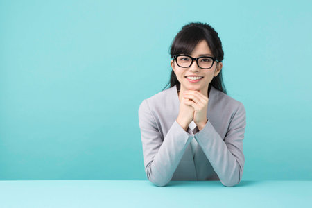 A woman smiling at a deskの写真素材