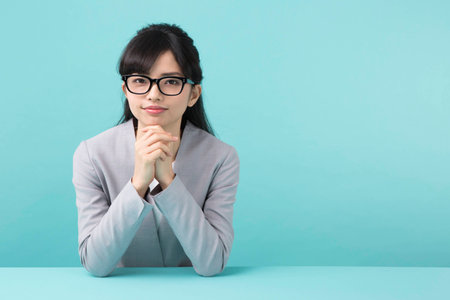 A woman smiling at a deskの写真素材
