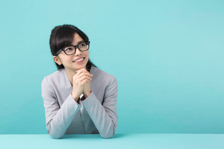 A woman smiling at a deskの写真素材