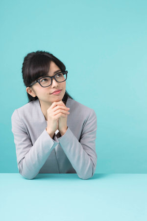 A woman smiling at a deskの写真素材