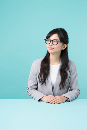 A woman smiling at a deskの写真素材