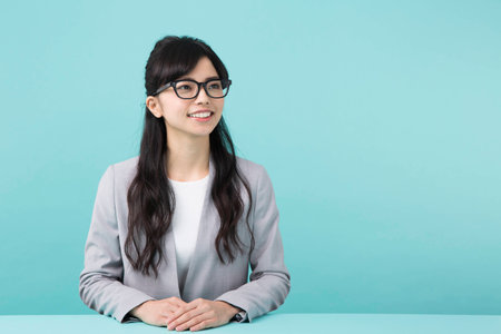 A woman smiling at a deskの写真素材