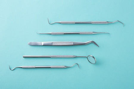 Dental tools on green background