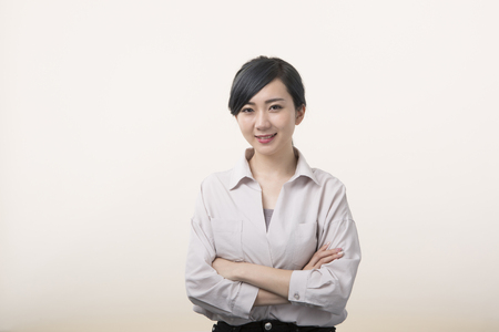 Young woman smiling with arms crossedの写真素材
