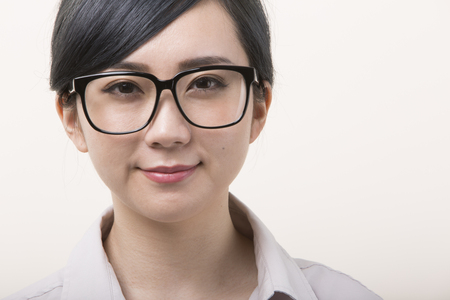 Young woman wearing black framed eyeglasses smilesの写真素材