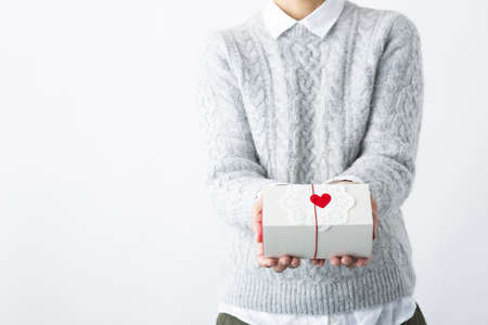 Gift box on a woman's handsの写真素材