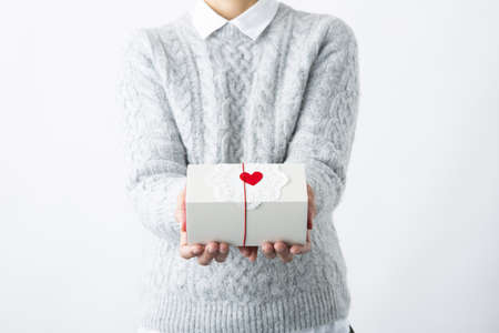 Gift box on a woman's handsの写真素材