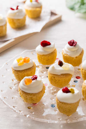 A small sponge cake decorated with fresh cream and dried fruitの写真素材