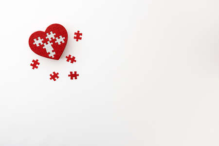 a heart-shaped puzzle placed on a white backgroundの写真素材