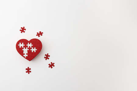 a heart-shaped puzzle placed on a white backgroundの写真素材
